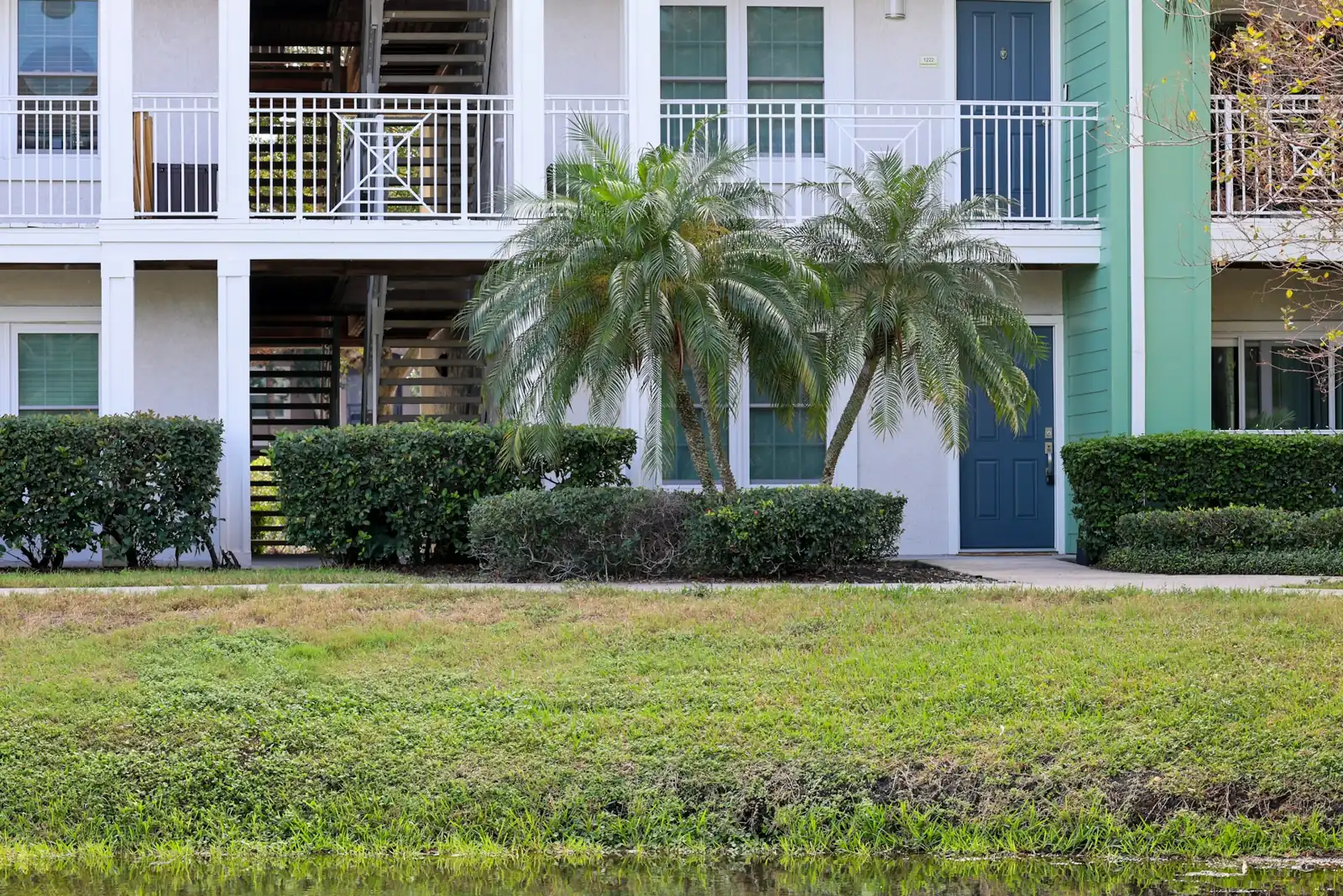 Garden-style apartments with palms and landscaping (representative image)